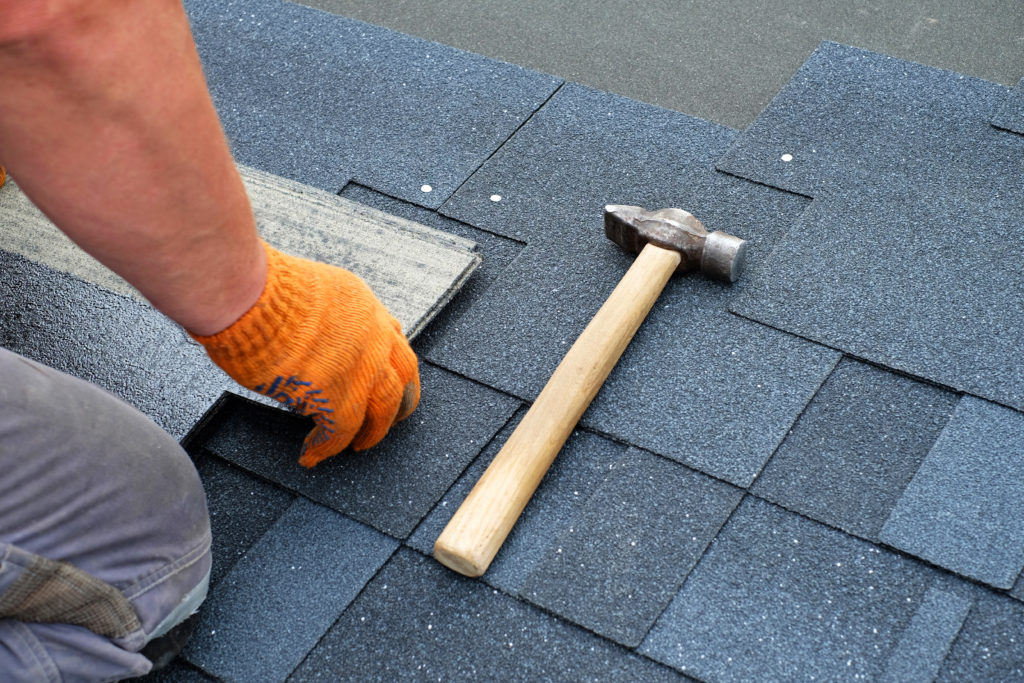 Roofer installing a roof replacement