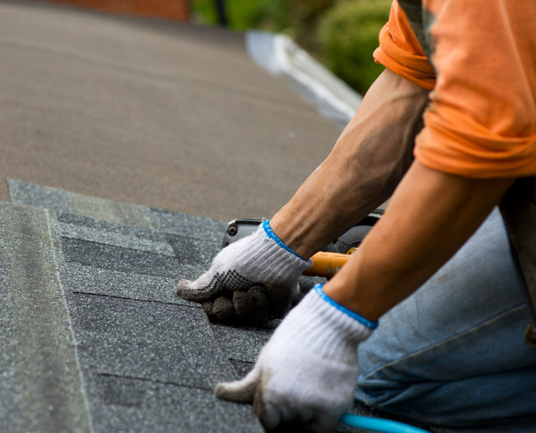 roofer installing shingles