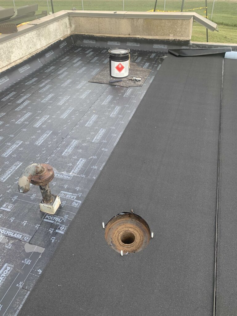 flat roof membrane being installed on a flat roof